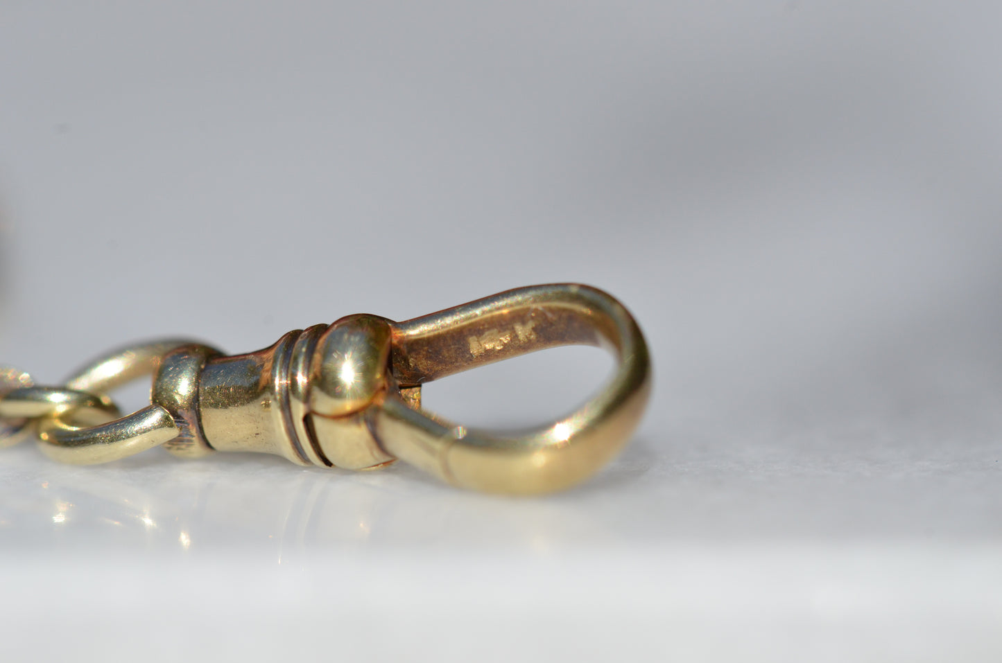 A closely cropped photo of the gold purity stamp on the inside of the clasp.