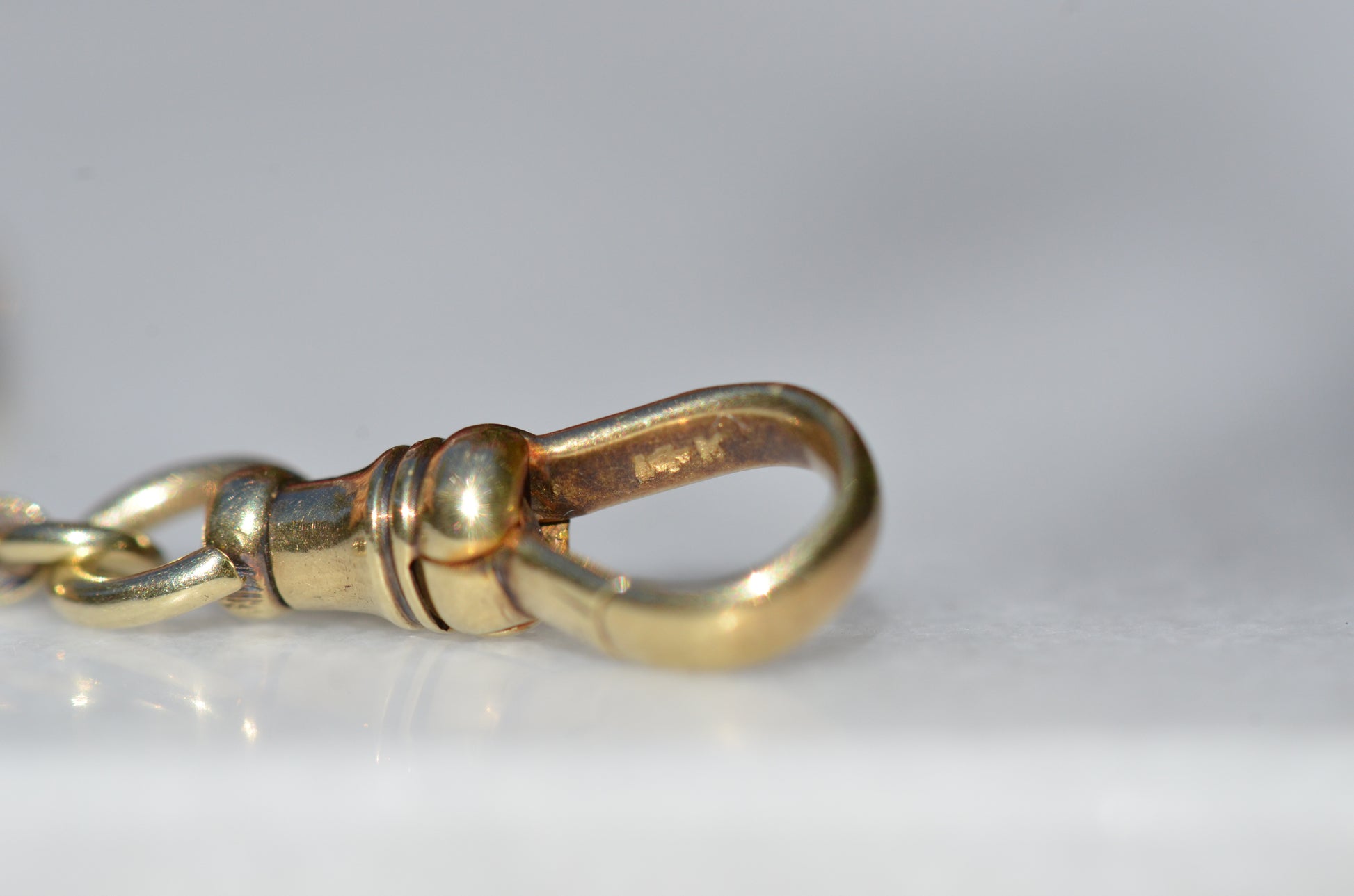 A closely cropped photo of the gold purity stamp on the inside of the clasp.