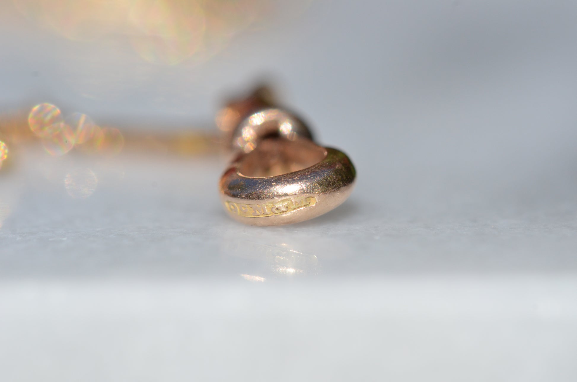 Worn British hallmarks on the outer edge of the dog clip clasp.