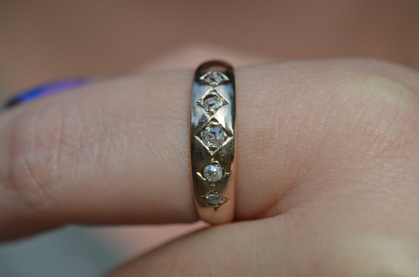 A tightly cropped macro of the ring on the left pointer finger of a Caucasian model.