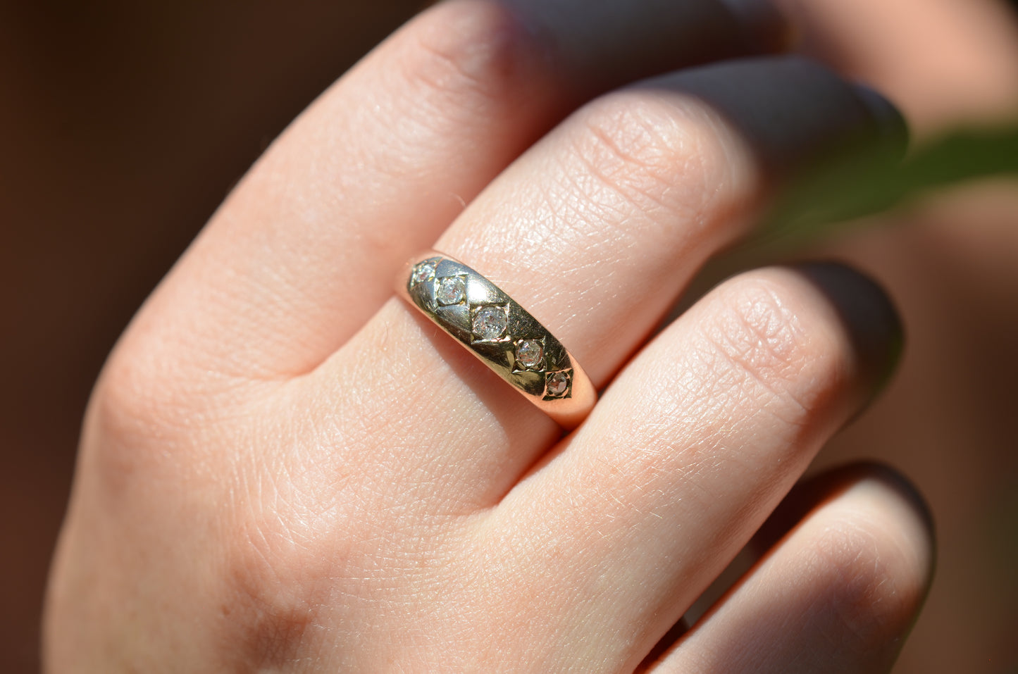 A tightly cropped macro of the ring on the right middle finger of a Caucasian model.