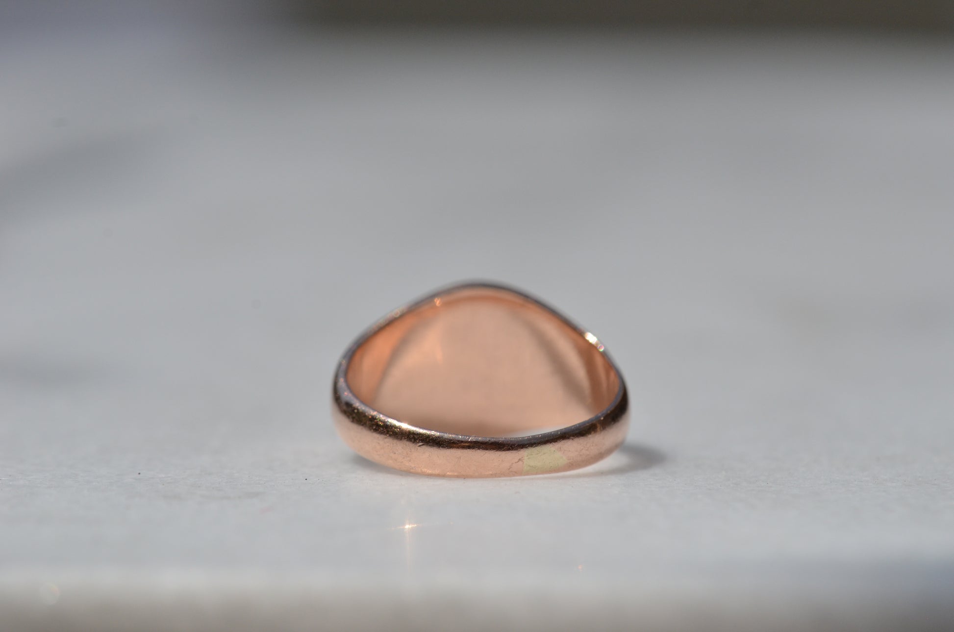 The back of the ring is shown with the band in focus, with a lightly visible solder seam showing evidence of past resizing.