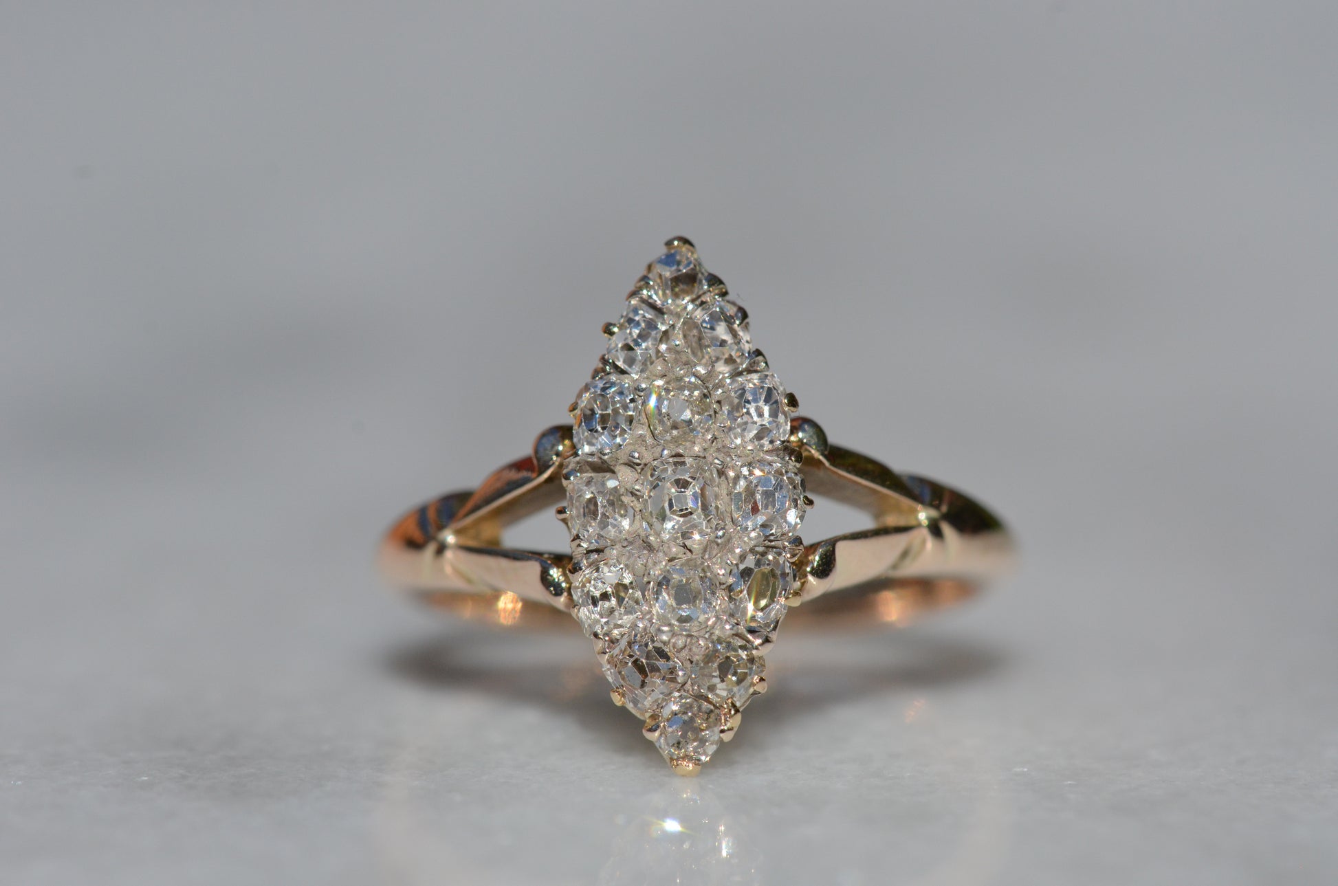 The closely cropped macro of this Victorian diamond navette ring is photographed head-on to show the detail of the face and clear diamond faceting.