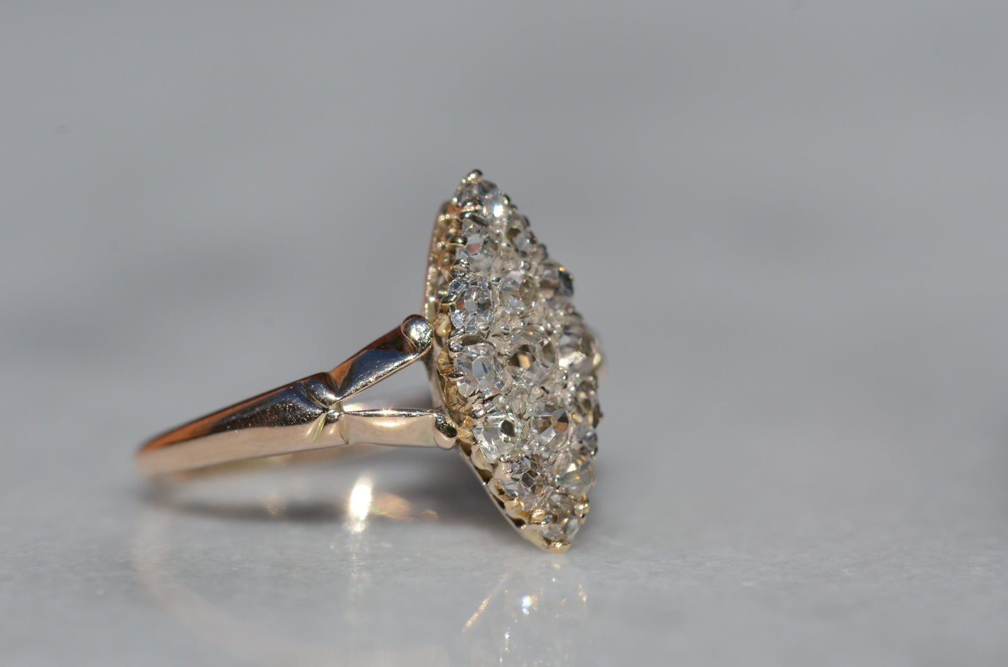 The closely cropped macro of this Victorian diamond navette ring is photographed turned to the right to highlight the split shoulder detail of the band.