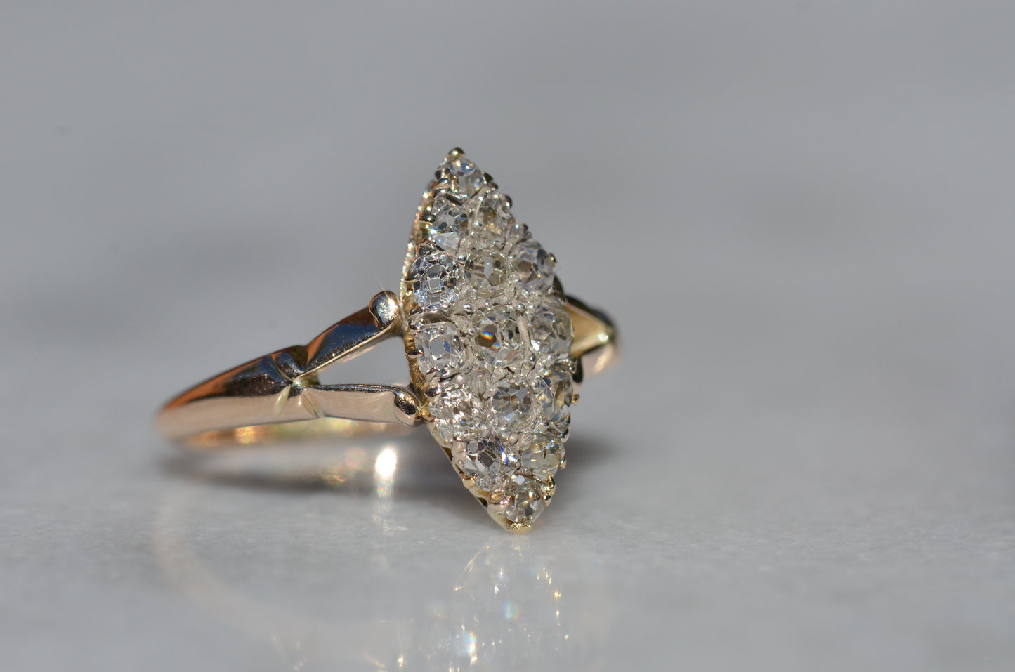 The closely cropped macro of this Victorian diamond navette ring is photographed turned slightly to the right to showcase the high rise of the crowns of each hand-cut diamond.
