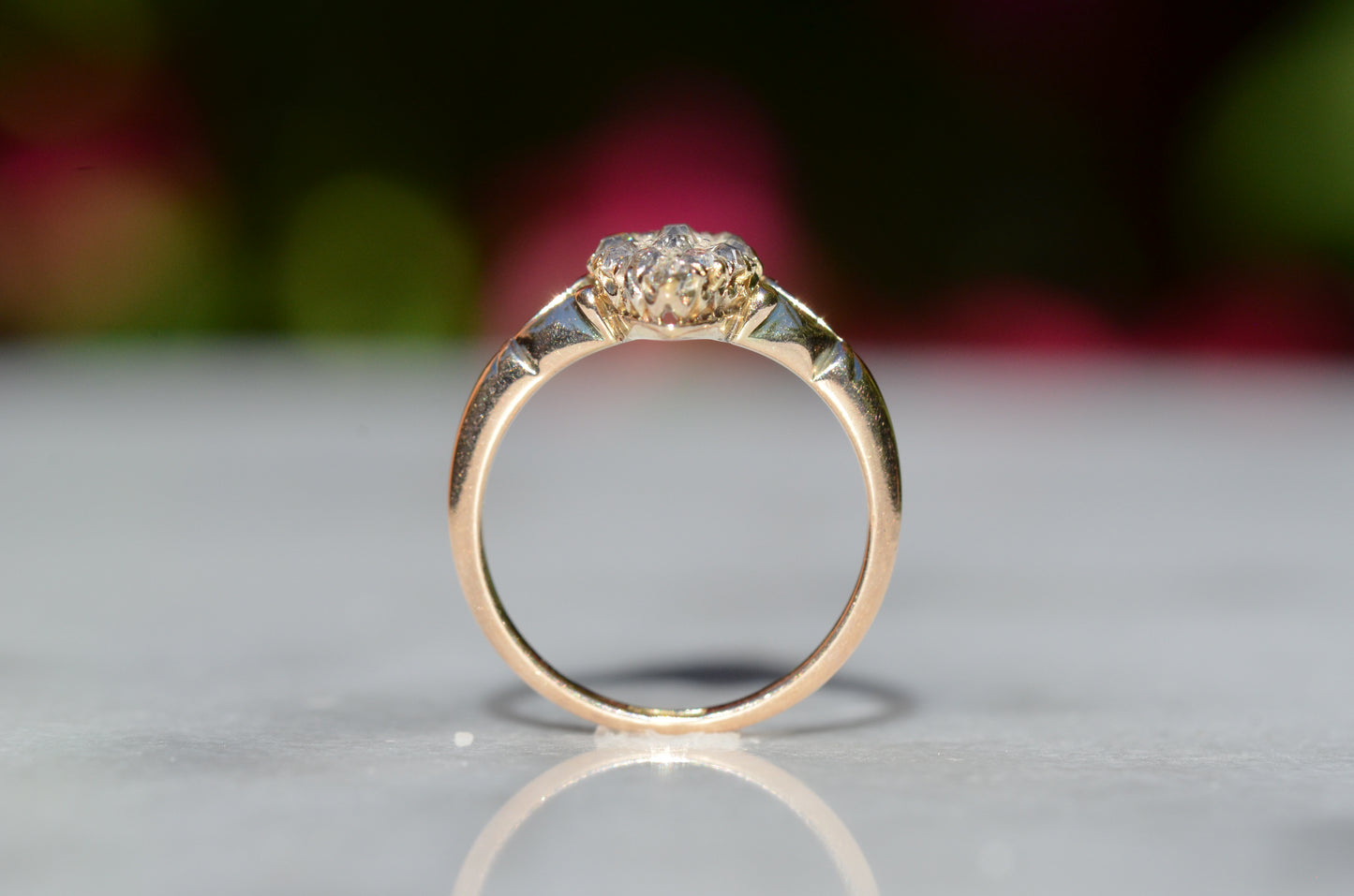 The closely cropped macro of this Victorian diamond navette ring is photographed positioned upright and looking through the finger hole to showcase the low rise off the finger.