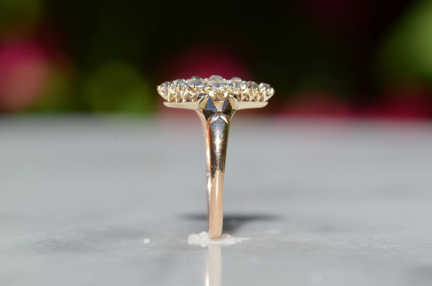 The closely cropped macro of this Victorian diamond navette ring is photographed positioned upright and viewed from the side to highlight the profile of the ring.