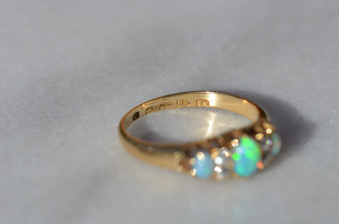 A closely-cropped macro of the Victorian ring. The ring is photographed looking into the band to see the British hallmark stamps within.