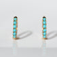 the earrings are displayed head-on, on a stark white background.