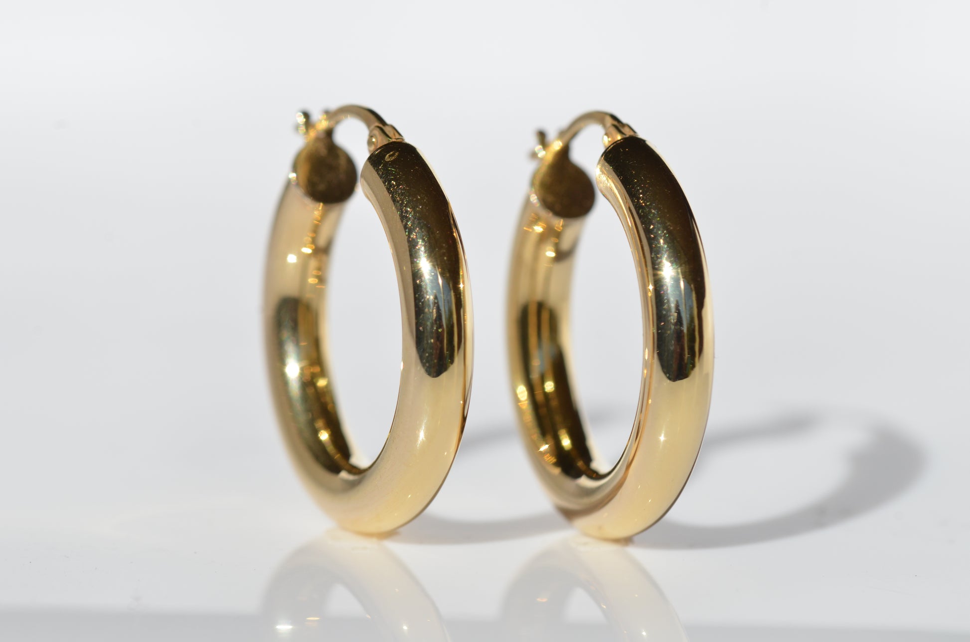 on a stark white background, the hoop earrings are stood upright and turned slightly to the right to provide a full view.